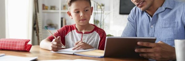 hispanic-pre-teen-boy-sitting-table-working-his-home-school-tutor-using-tablet-computer-144582842