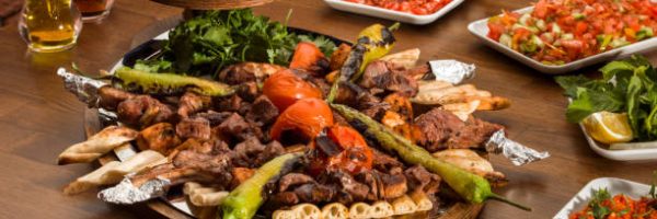 Traditional Turkish Kebabson wooden table. Kebabs are various cooked meat dishes, with their origins in Middle Eastern cuisine.