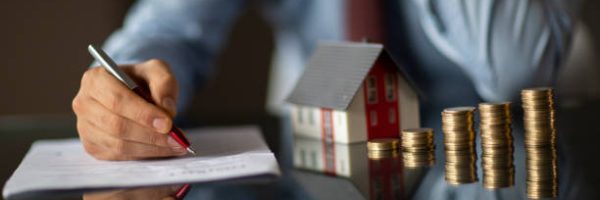 Real estate agent is holding a house model