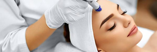 Face Skin Care. Close-up Of Woman Getting Facial Hydro Microdermabrasion Peeling Treatment At Cosmetic Beauty Spa Clinic. Hydra Vacuum Cleaner. Exfoliation, Rejuvenation And Hydratation. Cosmetology.