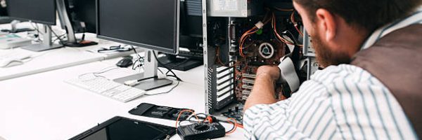 Broken computer disassembling, close-up. Repairman take apart CPU to find failure reason. Electronic repair, renovation concept