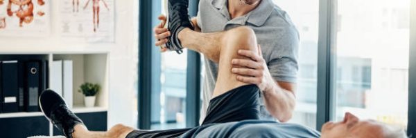 Shot of a friendly physiotherapist treating his mature patient in a rehabilitation center